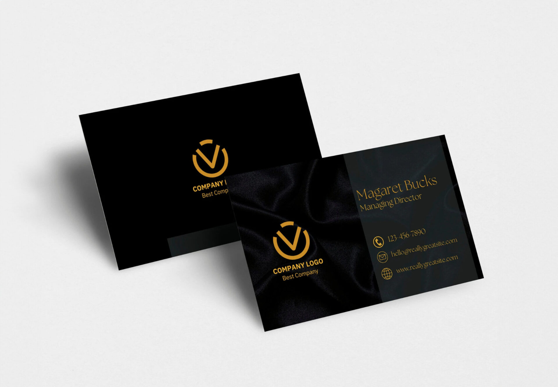 Black velvet business cards with gold logo and contact details