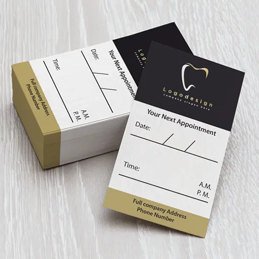 Stack of black and gold dental appointment cards