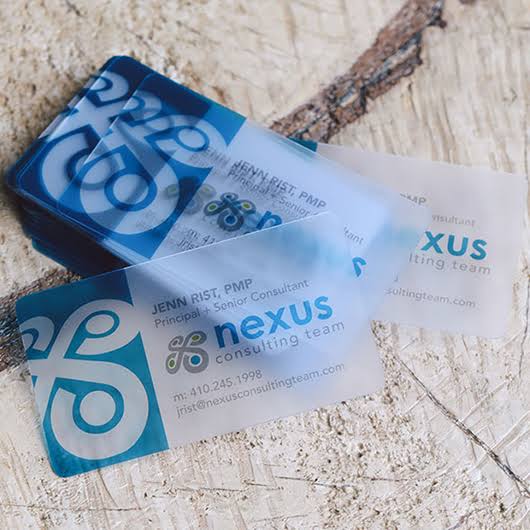 Clear plastic Nexus consulting cards with teal logo printing